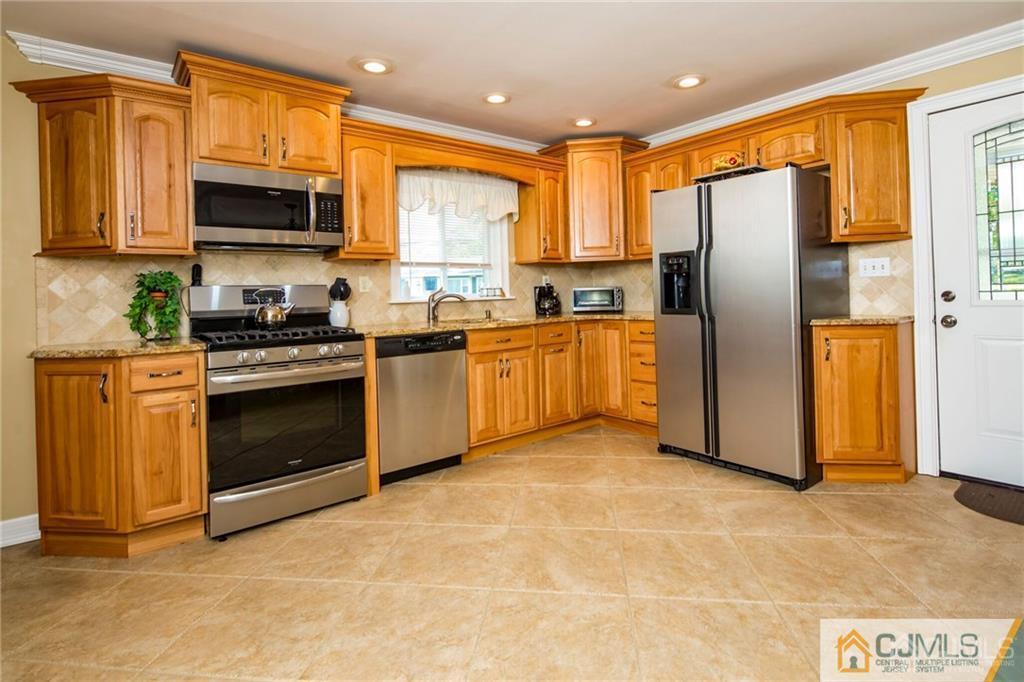 125 Princeton Road Old Bridge, NJ 08859 - Photo 8 of 26 a kitchen with stainless steel appliances granite countertop a stove top oven a refrigerator and a stove
