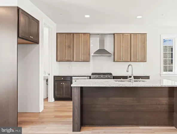 a kitchen with stainless steel appliances granite countertop a sink and cabinets