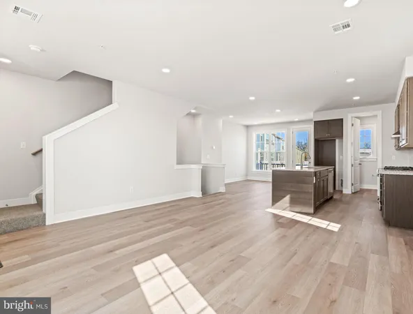 a view of a kitchen with furniture and a wooden floor