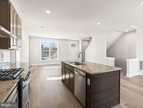 a kitchen with stainless steel appliances granite countertop a stove and a sink