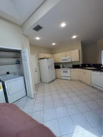 a kitchen with refrigerator and cabinets