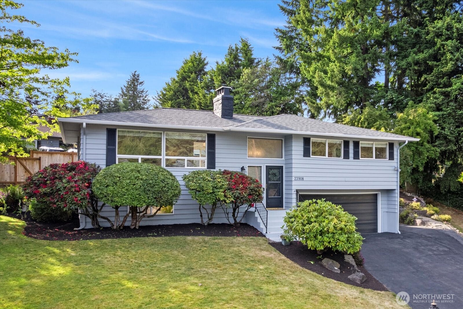a front view of house with yard and outdoor seating