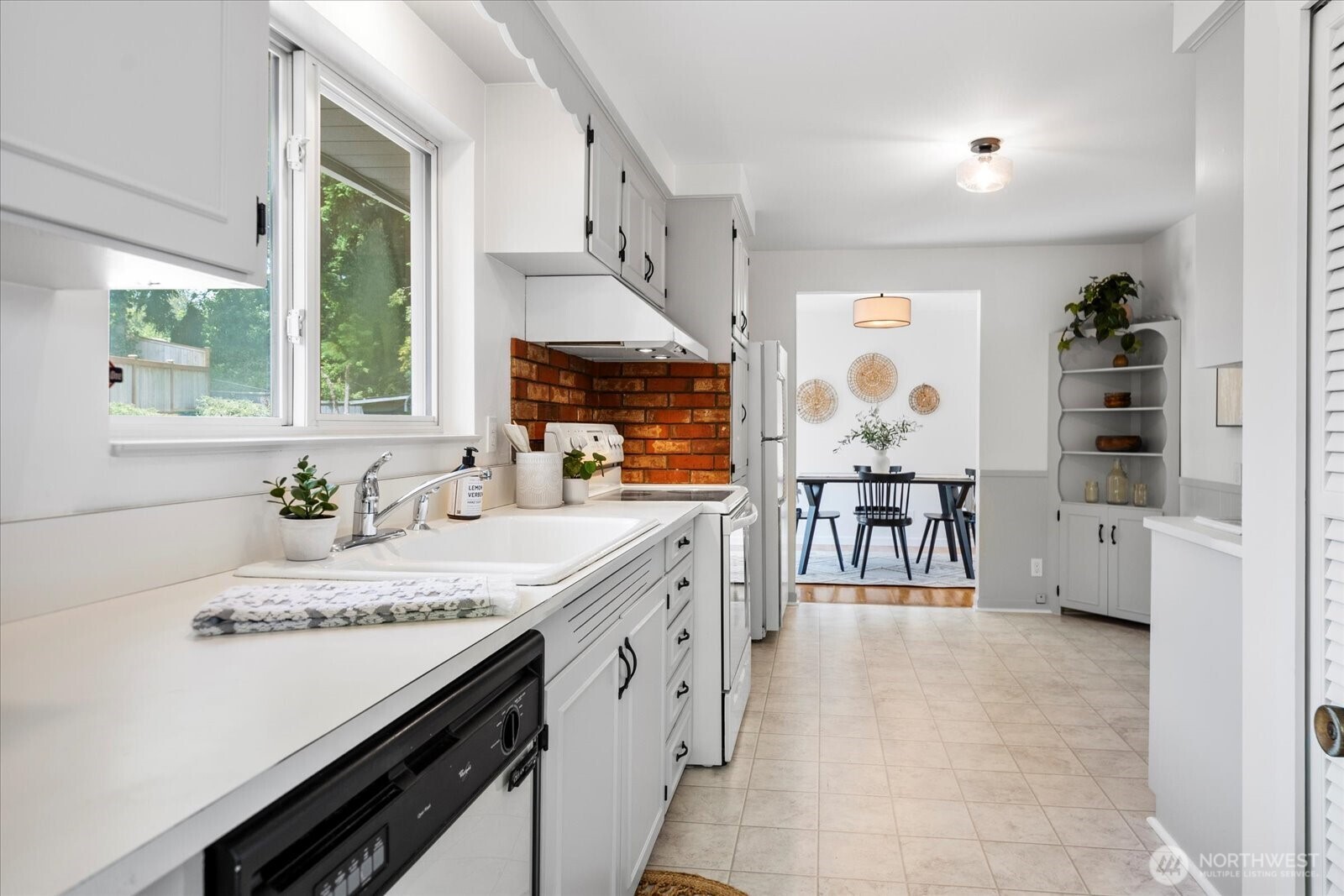 23908 80th Place West Edmonds, WA 98026 - Photo 11 of 40 a kitchen with stainless steel appliances a stove a sink and a refrigerator