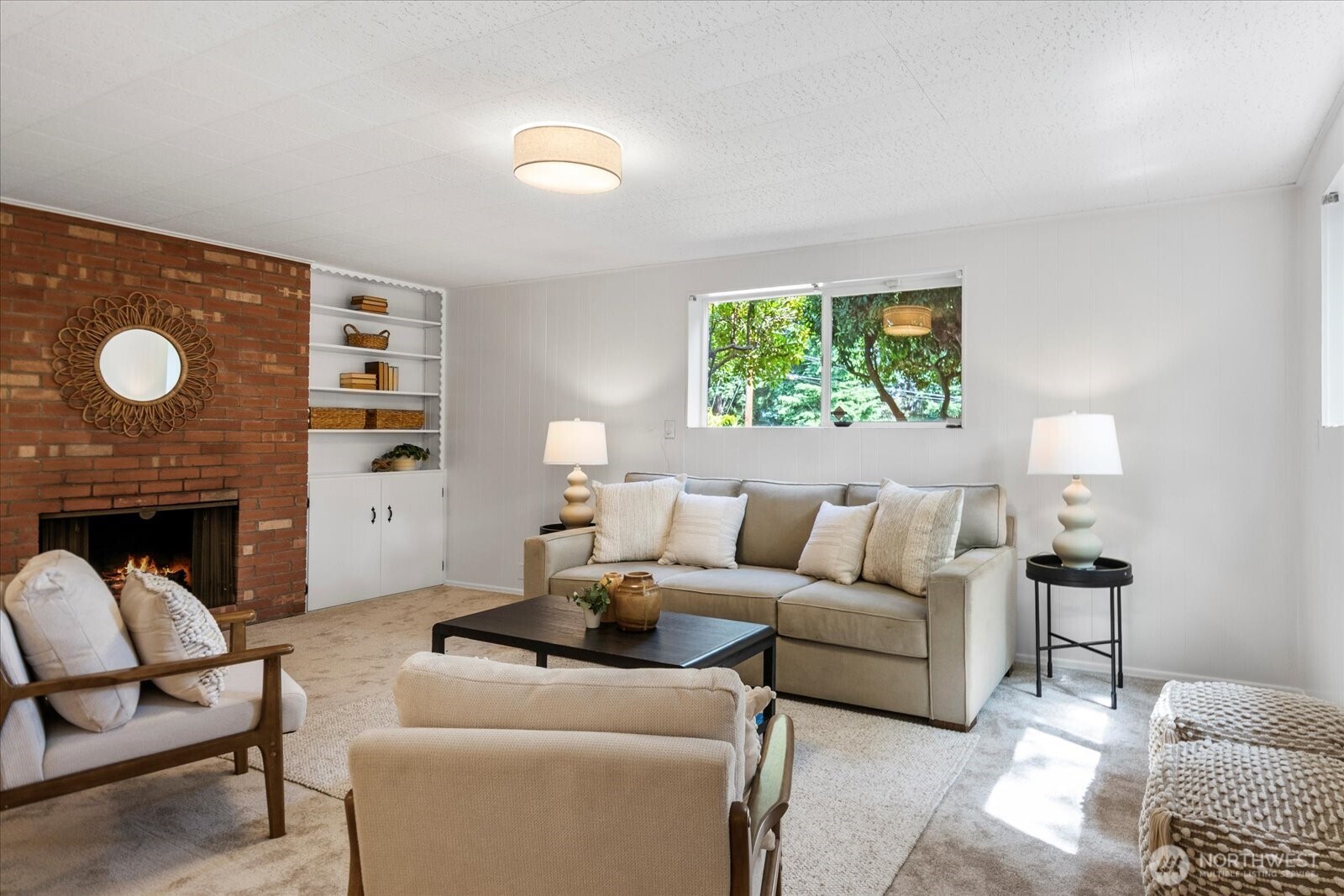 23908 80th Place West Edmonds, WA 98026 - Photo 24 of 40 a living room with furniture a fireplace and a large window