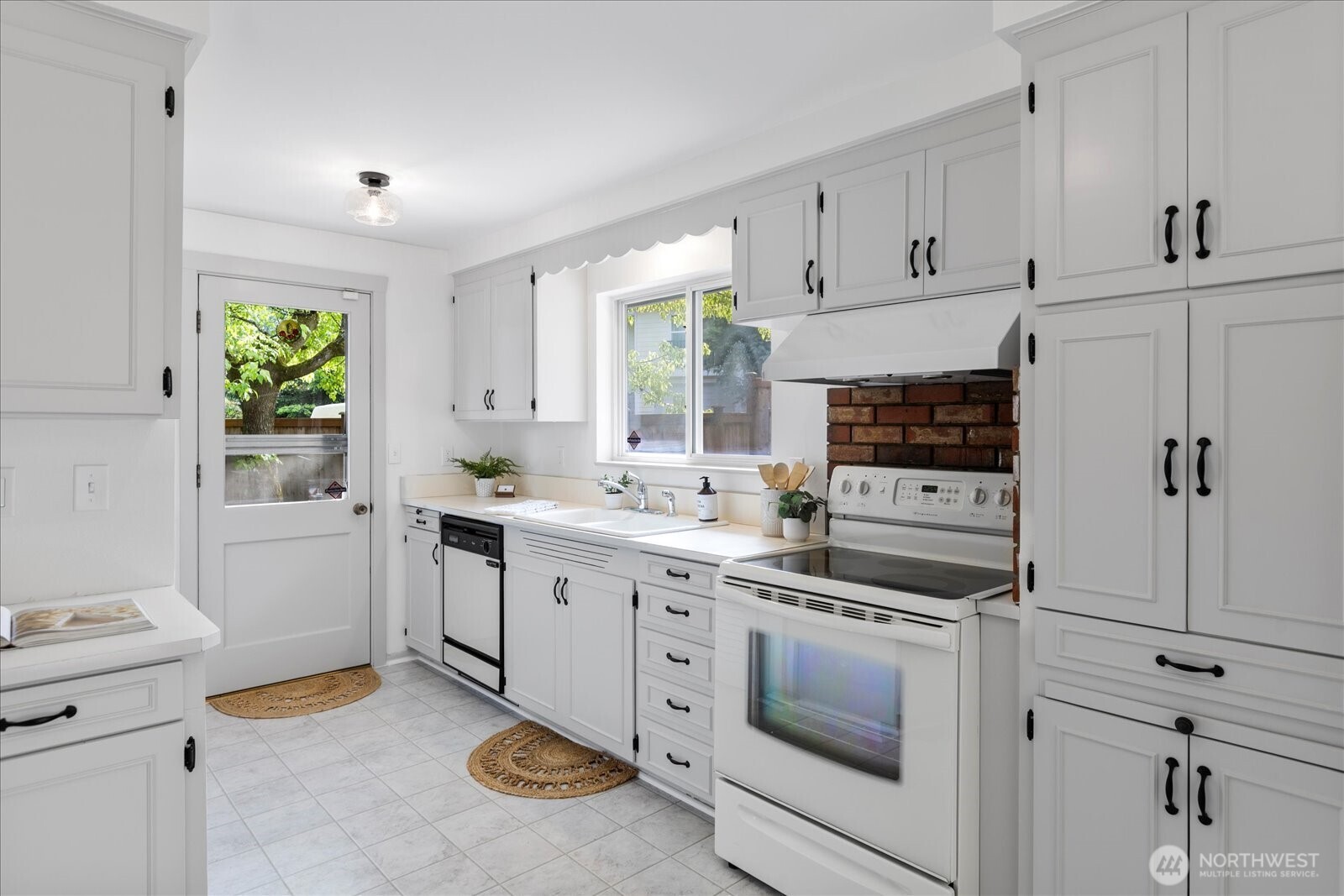 23908 80th Place West Edmonds, WA 98026 - Photo 8 of 40 a kitchen with white cabinets and white appliances