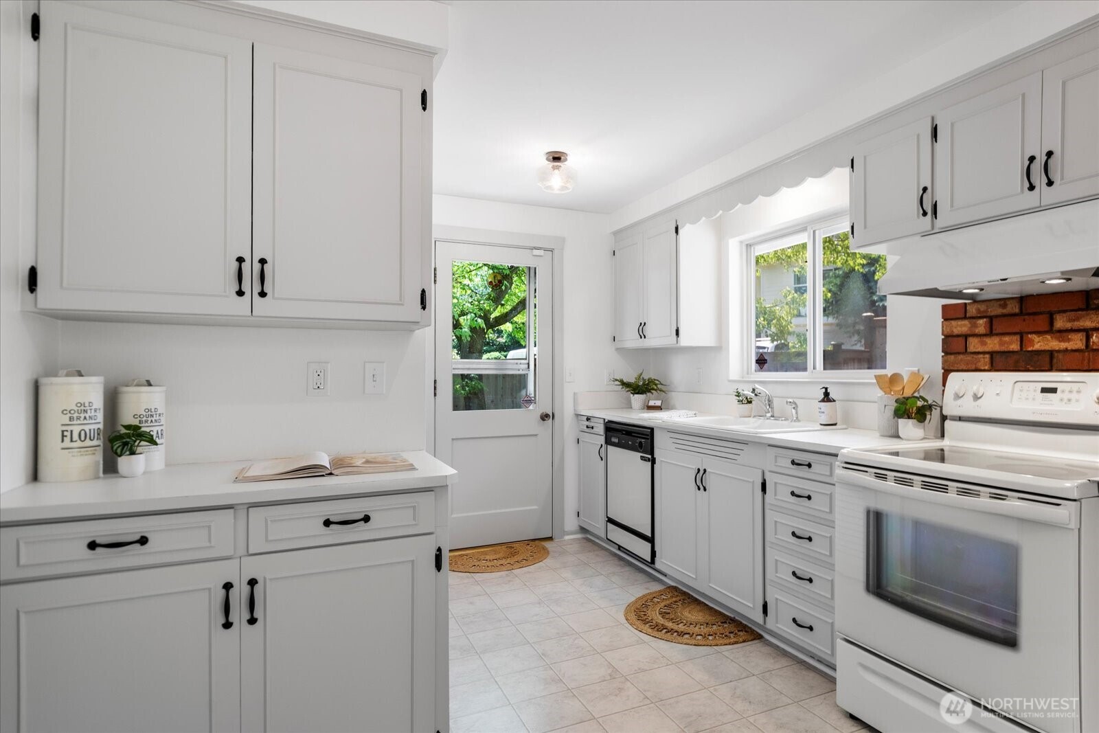 23908 80th Place West Edmonds, WA 98026 - Photo 9 of 40 a kitchen with white cabinets and white appliances