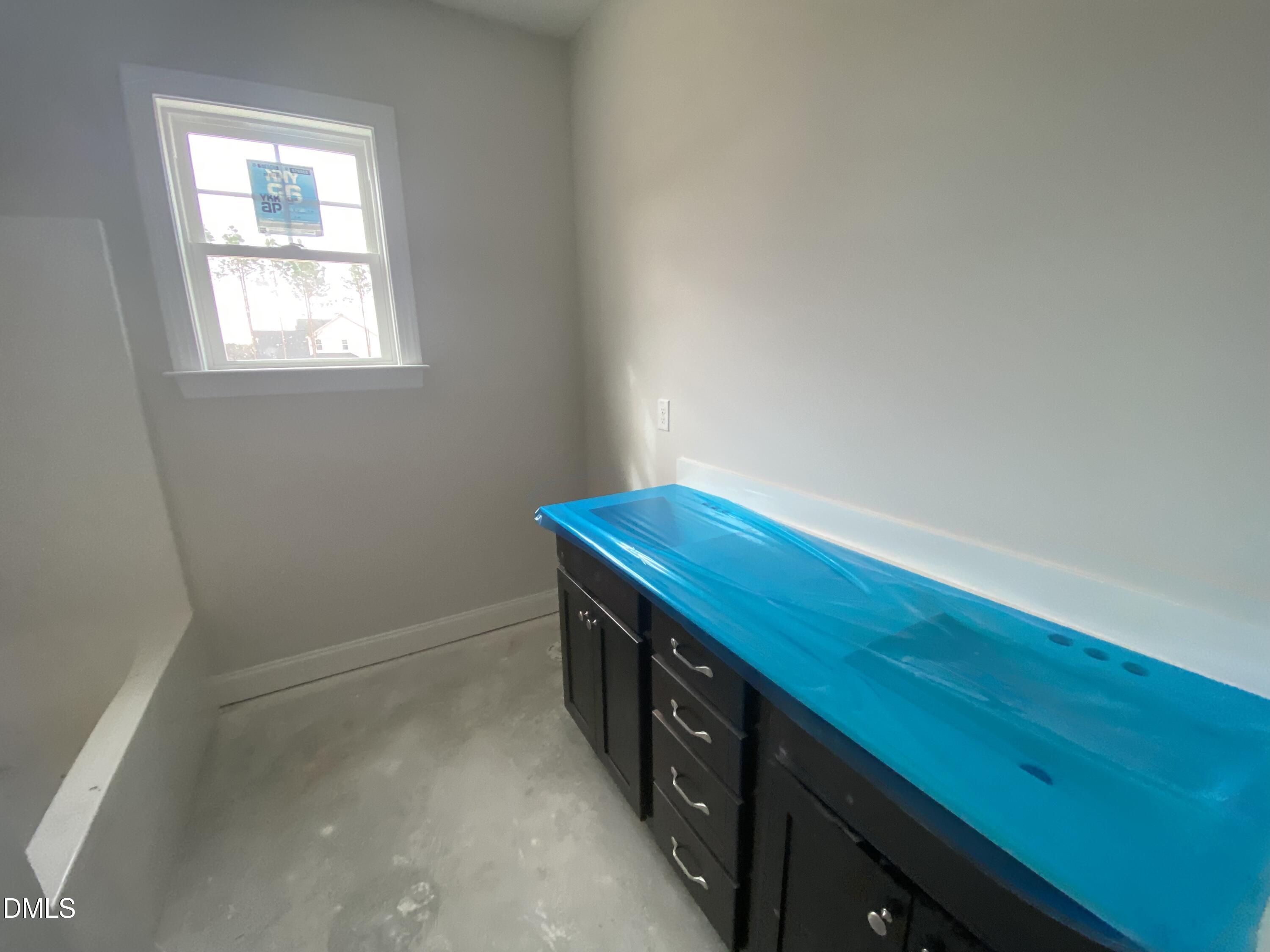 117 Rabbit Run Drive Smithfield, NC 27577 - Photo 13 of 16 a bathroom with a double vanity sink and a window