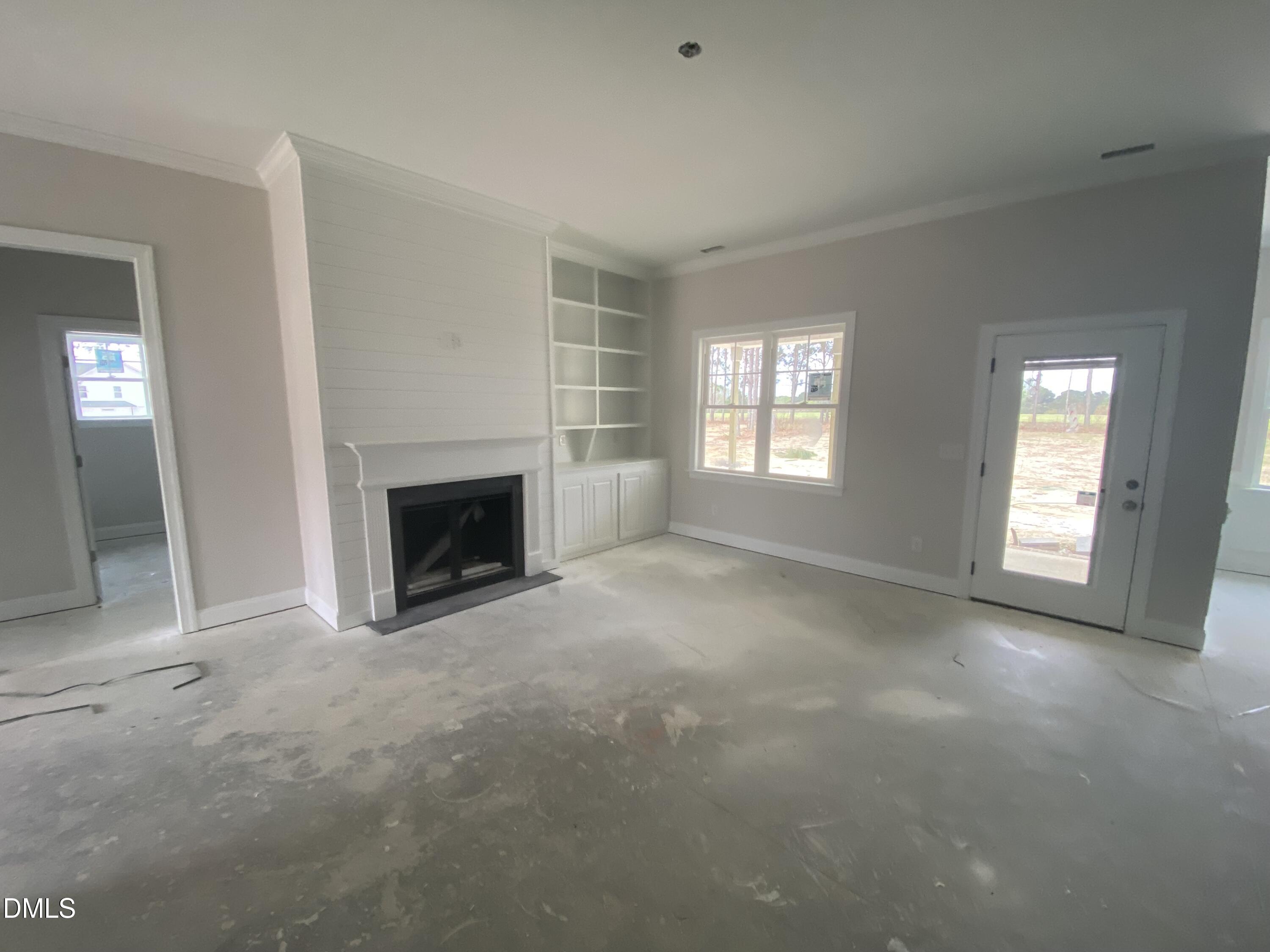 117 Rabbit Run Drive Smithfield, NC 27577 - Photo 4 of 16 an empty room with windows and fireplace