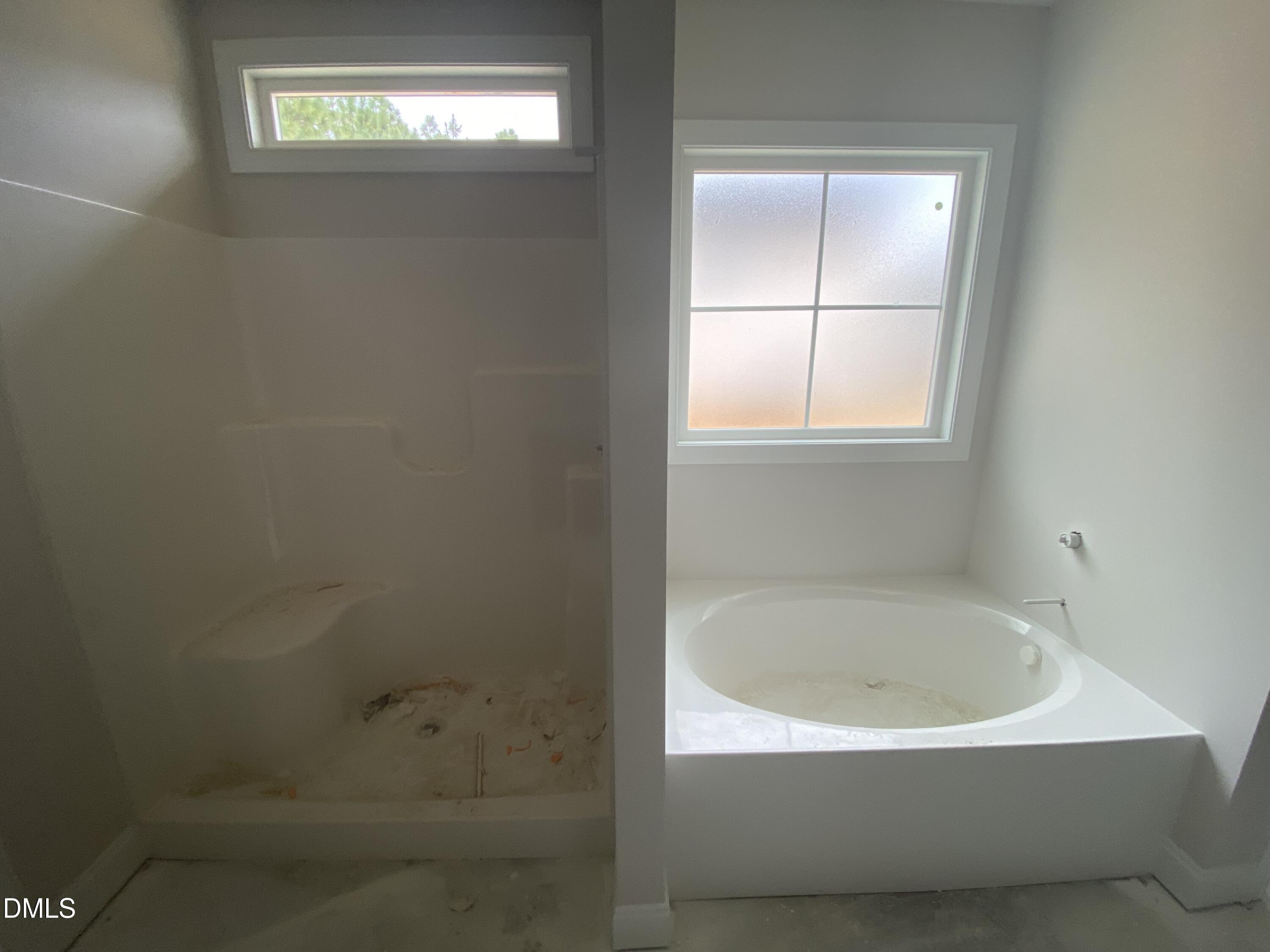 117 Rabbit Run Drive Smithfield, NC 27577 - Photo 9 of 16 a white bath tub sitting in a bathroom next to a window
