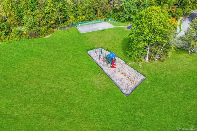 an aerial view of a house with garden space and street view