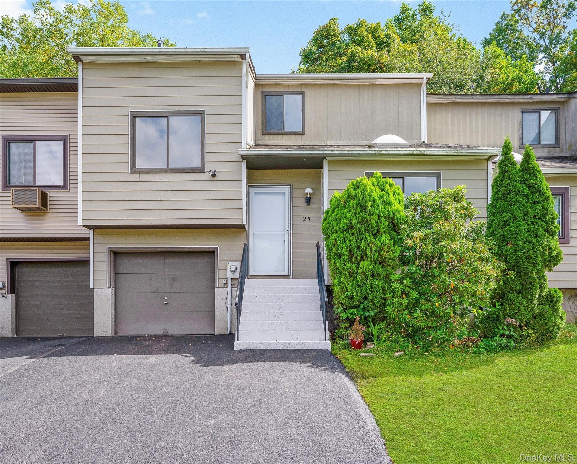 25 Laurel Court Fishkill, NY 12524 - Photo 25 of 26 a front view of a house with a yard and garage