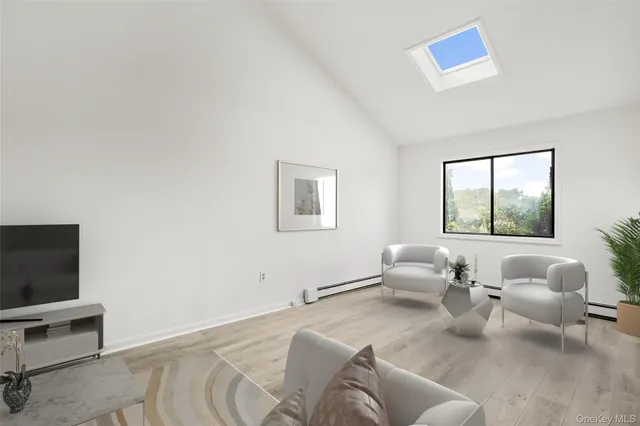 a living room with furniture a rug and a flat screen tv