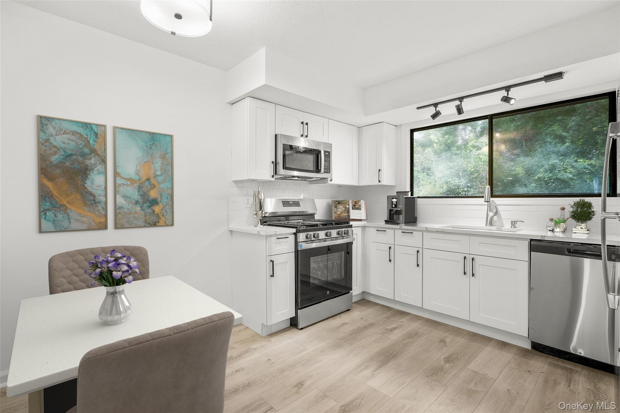 25 Laurel Court Fishkill, NY 12524 - Photo 5 of 26 a kitchen with a stove a sink and a refrigerator