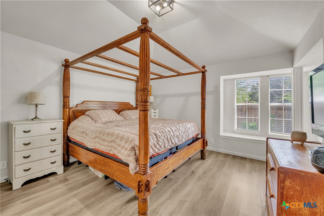 3905 Tyler Trail Temple, TX 76504 - Photo 13 of 31 a bedroom with a bed and a dresser next to a window
