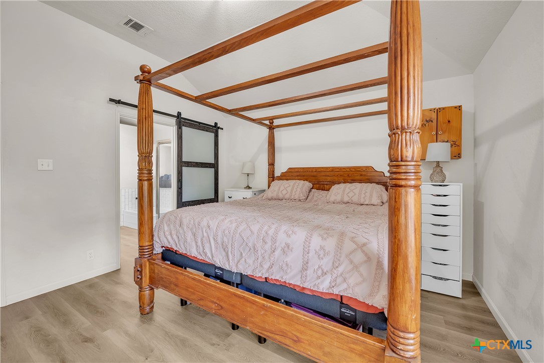 3905 Tyler Trail Temple, TX 76504 - Photo 14 of 31 a large bed sitting in a bedroom next to a window