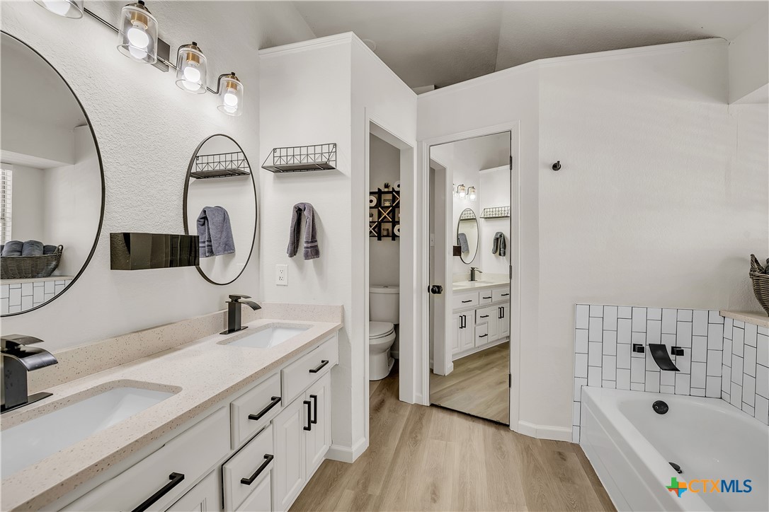 3905 Tyler Trail Temple, TX 76504 - Photo 17 of 31 a bathroom with a tub sink double vanity and shower