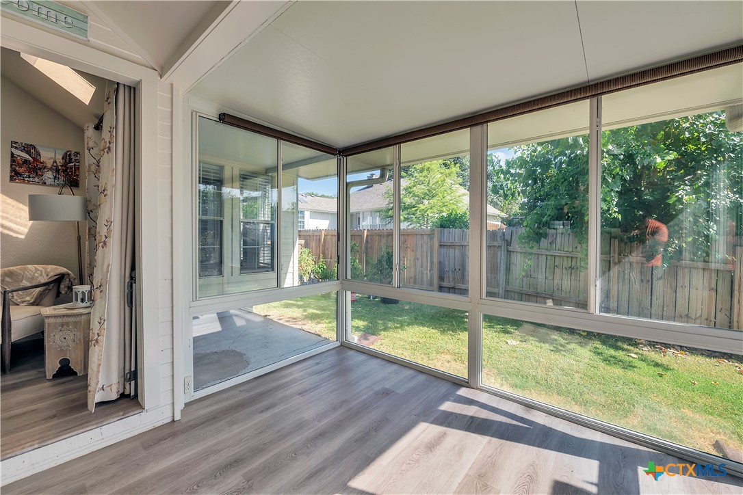 3905 Tyler Trail Temple, TX 76504 - Photo 26 of 31 a view of backyard with a large window and wooden floor