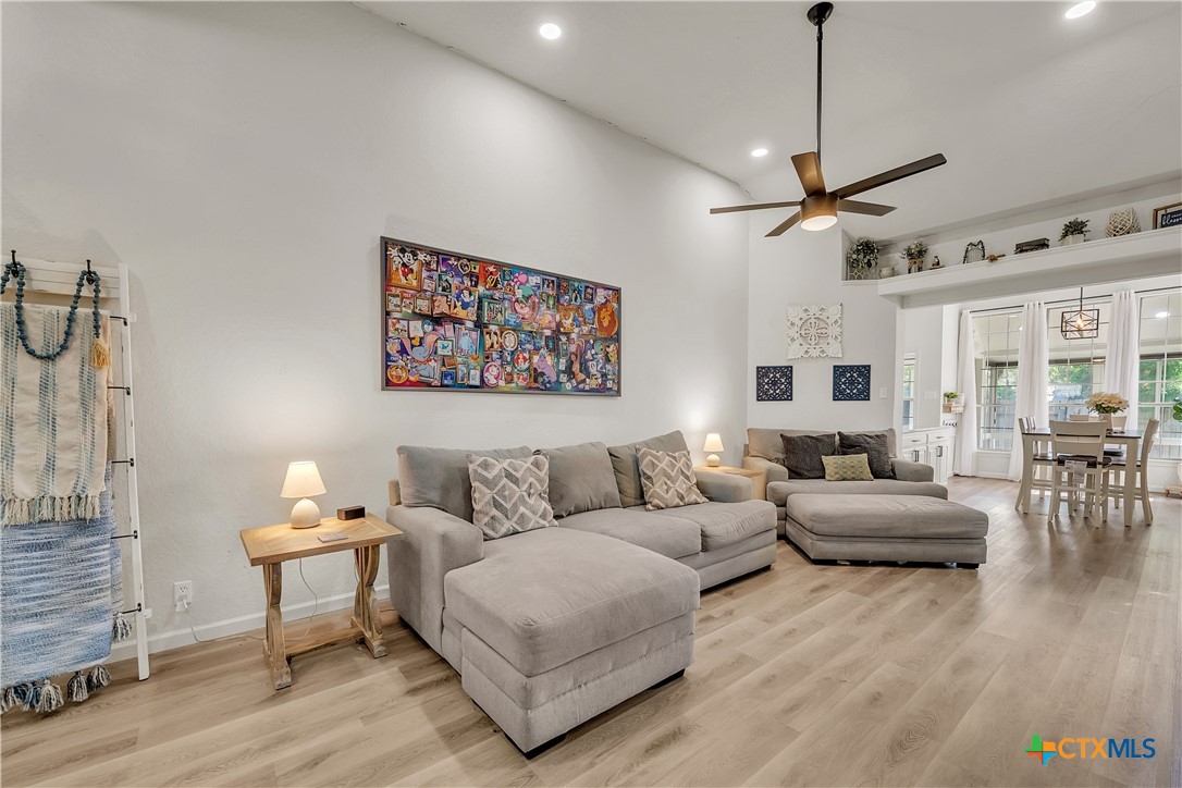 3905 Tyler Trail Temple, TX 76504 - Photo 5 of 31 a living room with furniture a chandelier and a wooden floor