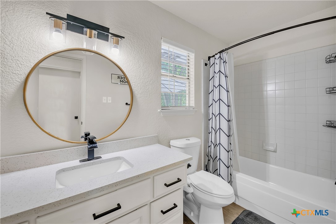 3905 Tyler Trail Temple, TX 76504 - Photo 8 of 31 a bathroom with a sink a mirror a toilet and a bathtub