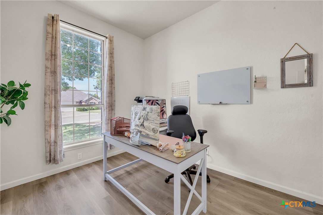 3905 Tyler Trail Temple, TX 76504 - Photo 9 of 31 a view of a workspace with wooden floor and a window
