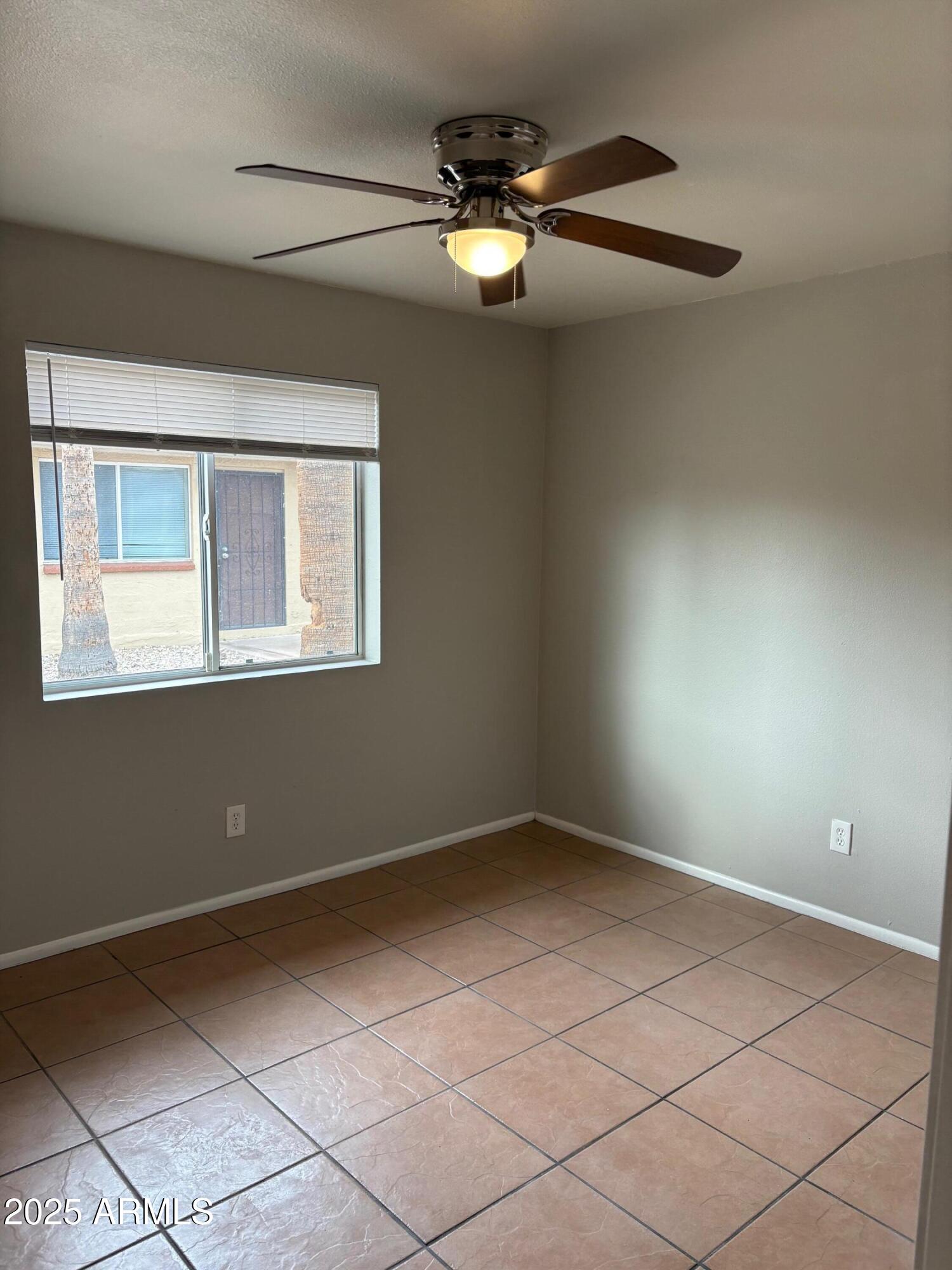 909 South Priest Drive, Unit 10 Tempe, AZ 85281 - Photo 5 of 14 a view of an empty room with a window