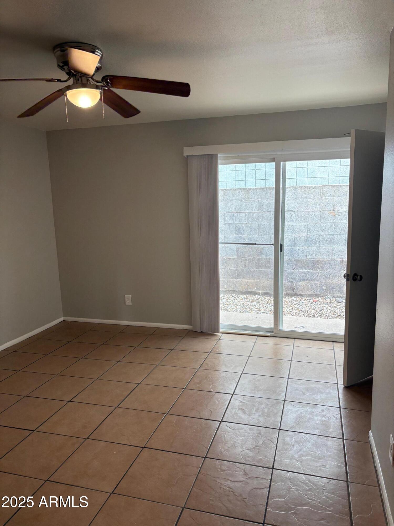 909 South Priest Drive, Unit 10 Tempe, AZ 85281 - Photo 7 of 14 a view of an empty room with a window