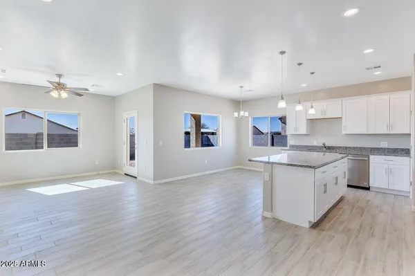 a large kitchen with stainless steel appliances granite countertop a stove a sink and a refrigerator