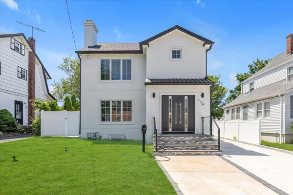 a front view of a house with a yard