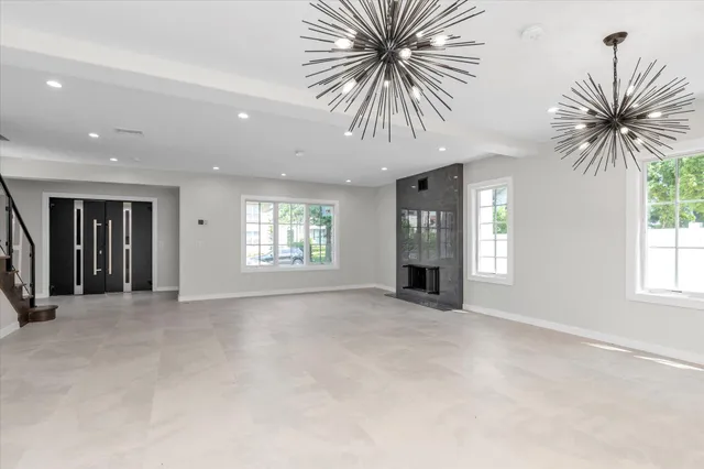 an empty room with windows and closet area