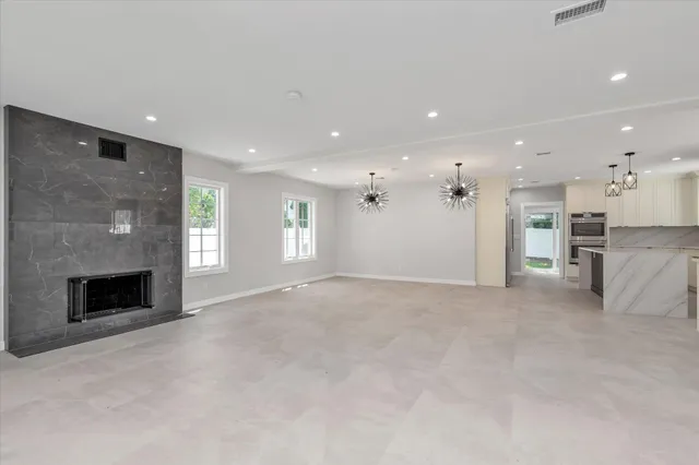 a view of empty room with a fireplace