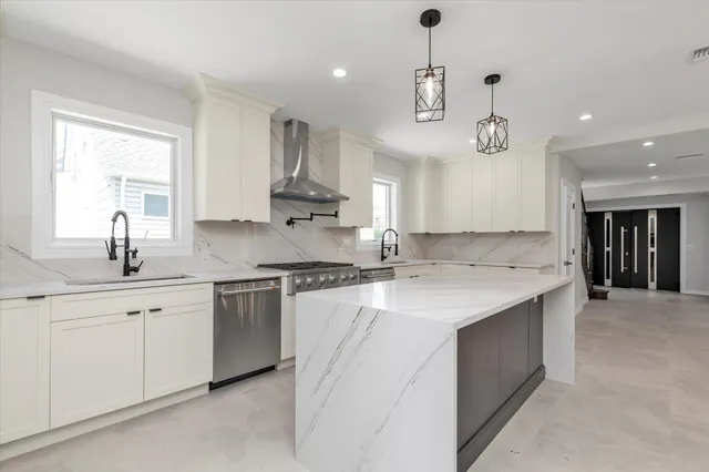 a kitchen with a sink chandelier and refrigerator
