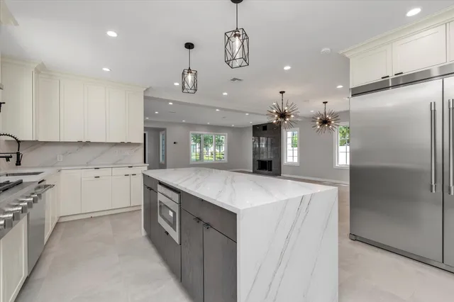 a kitchen with a stove a sink and a refrigerator