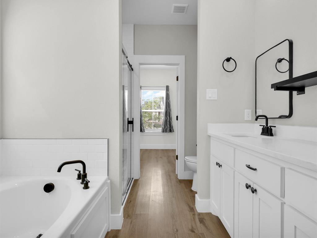 4905 Sweetbay Road Sherman, TX 75092 - Photo 18 of 26 a bathroom with a tub sink and mirror