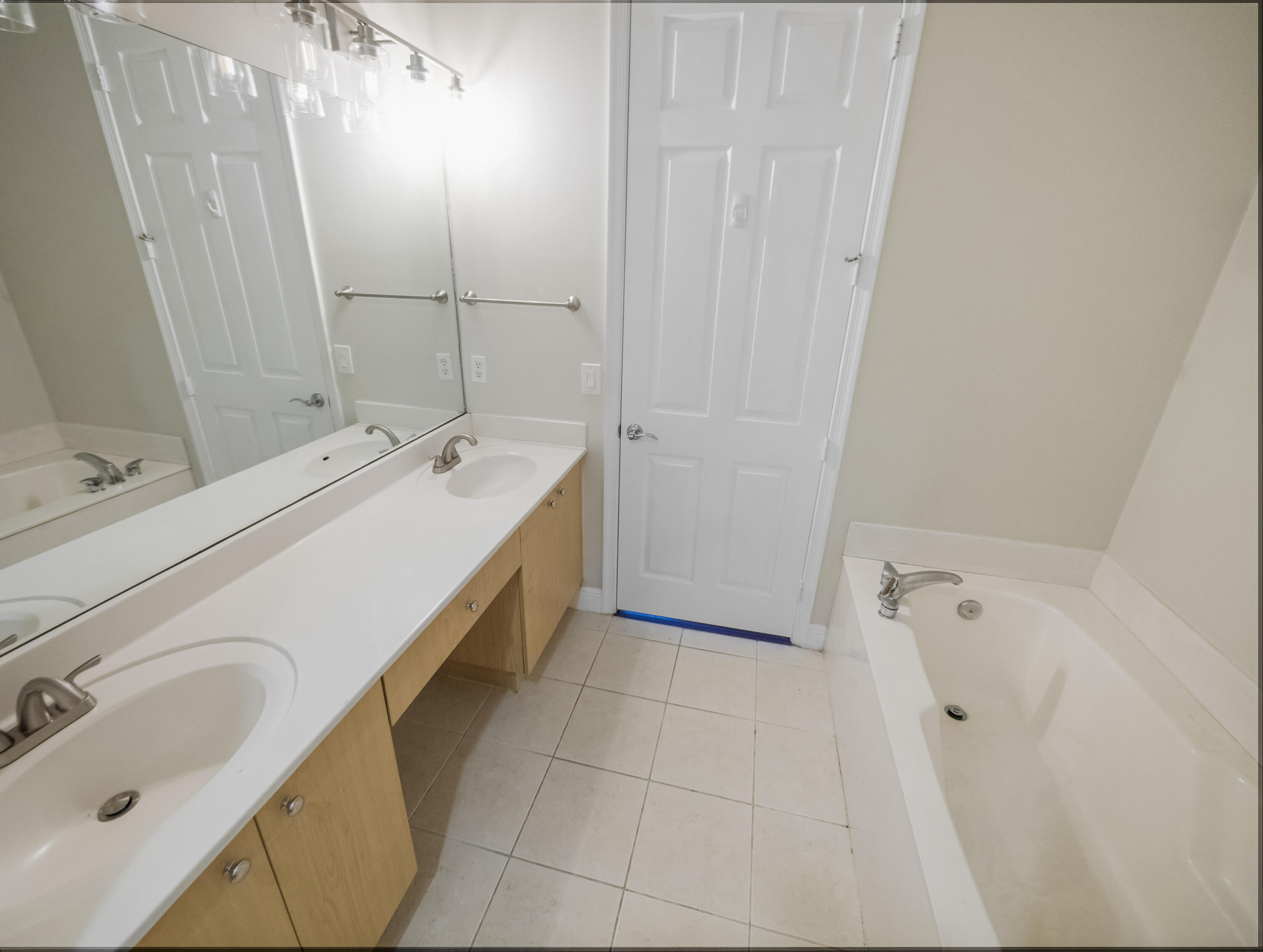 148 Morning Dew Circle Jupiter, FL 33458 - Photo 16 of 21 a bathroom with a double vanity sink and mirror with bathtub