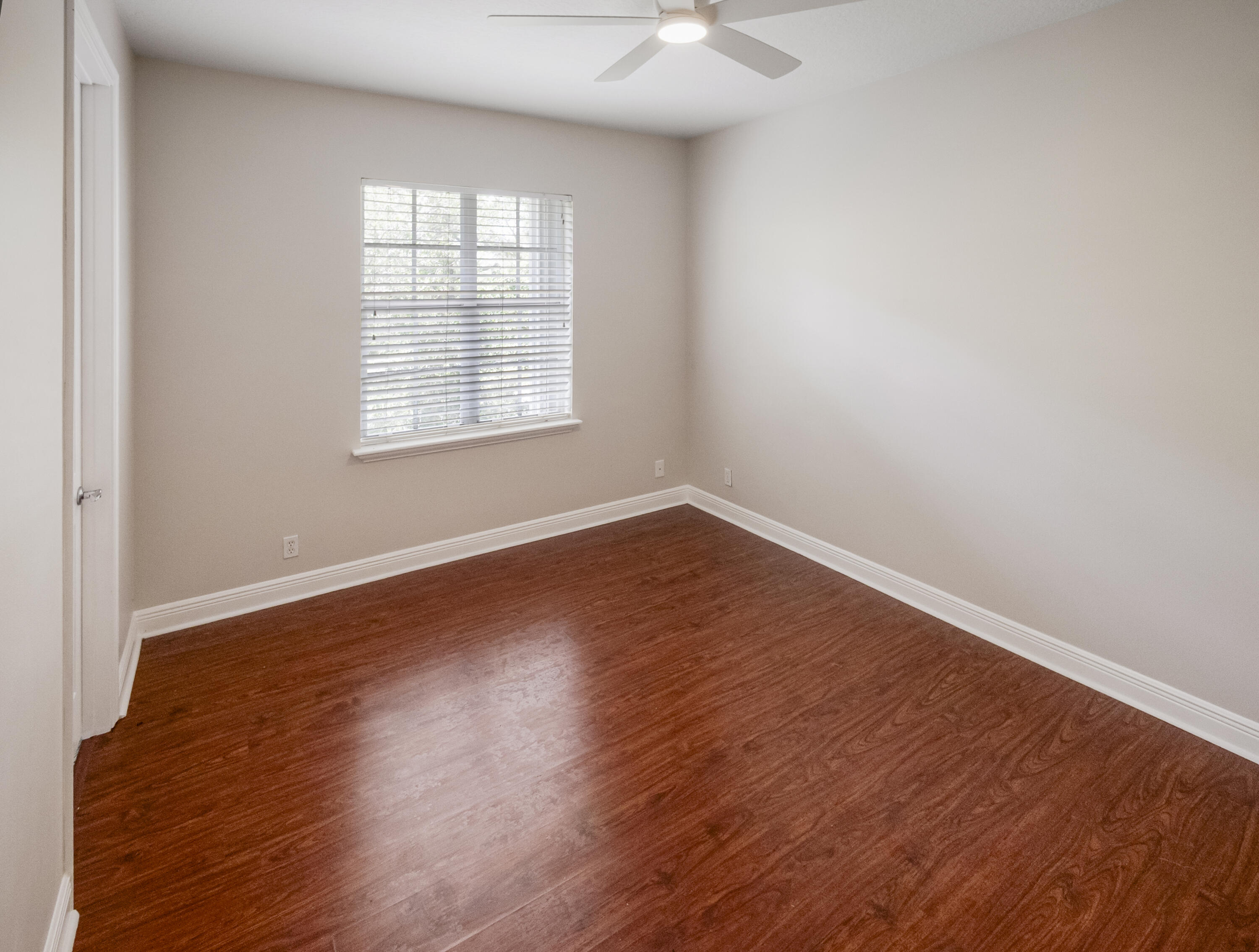 148 Morning Dew Circle Jupiter, FL 33458 - Photo 17 of 21 an empty room with wooden floor and windows