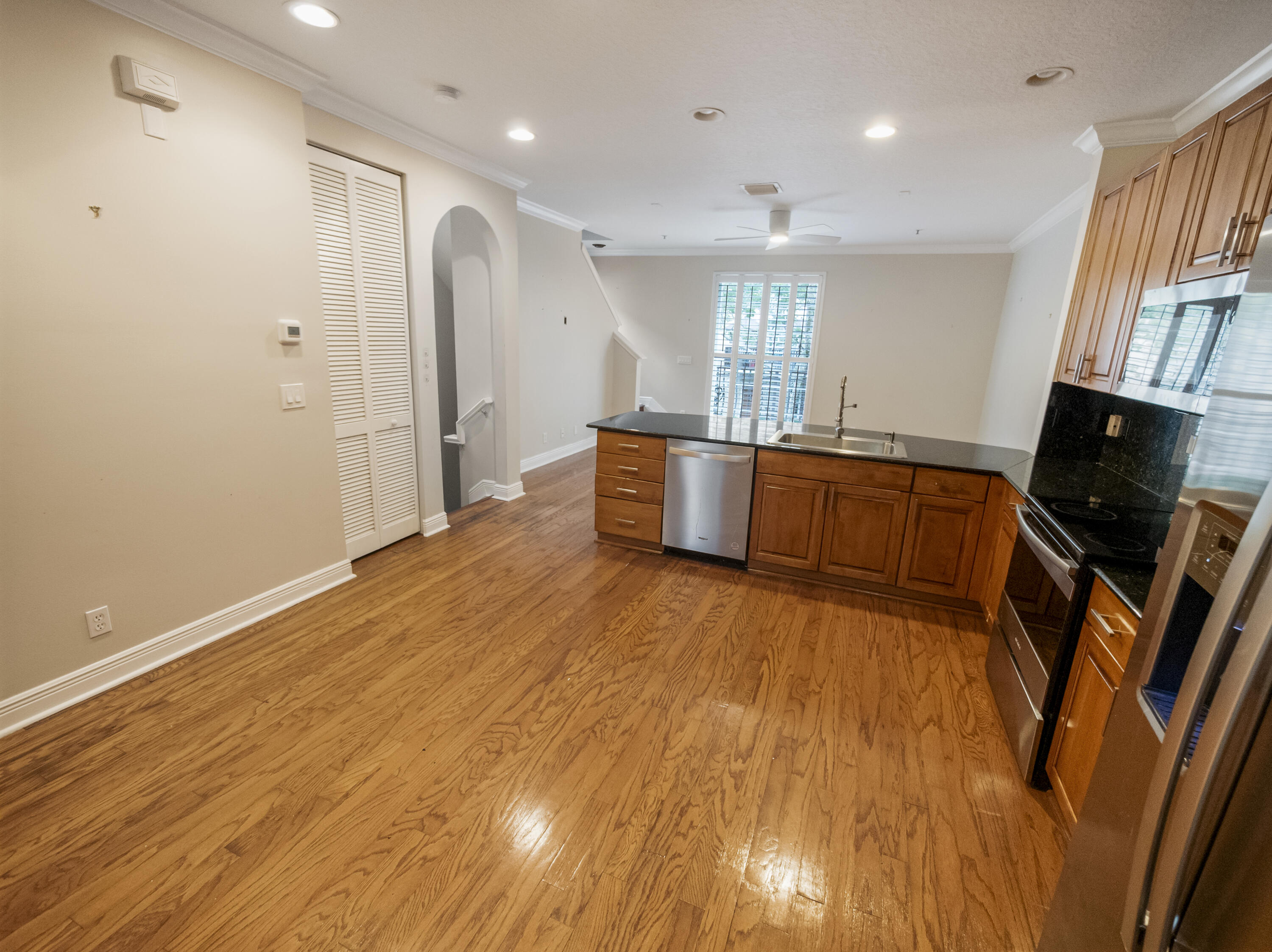 148 Morning Dew Circle Jupiter, FL 33458 - Photo 4 of 21 a large kitchen with stainless steel appliances granite countertop a large counter top a stove and a wooden floors
