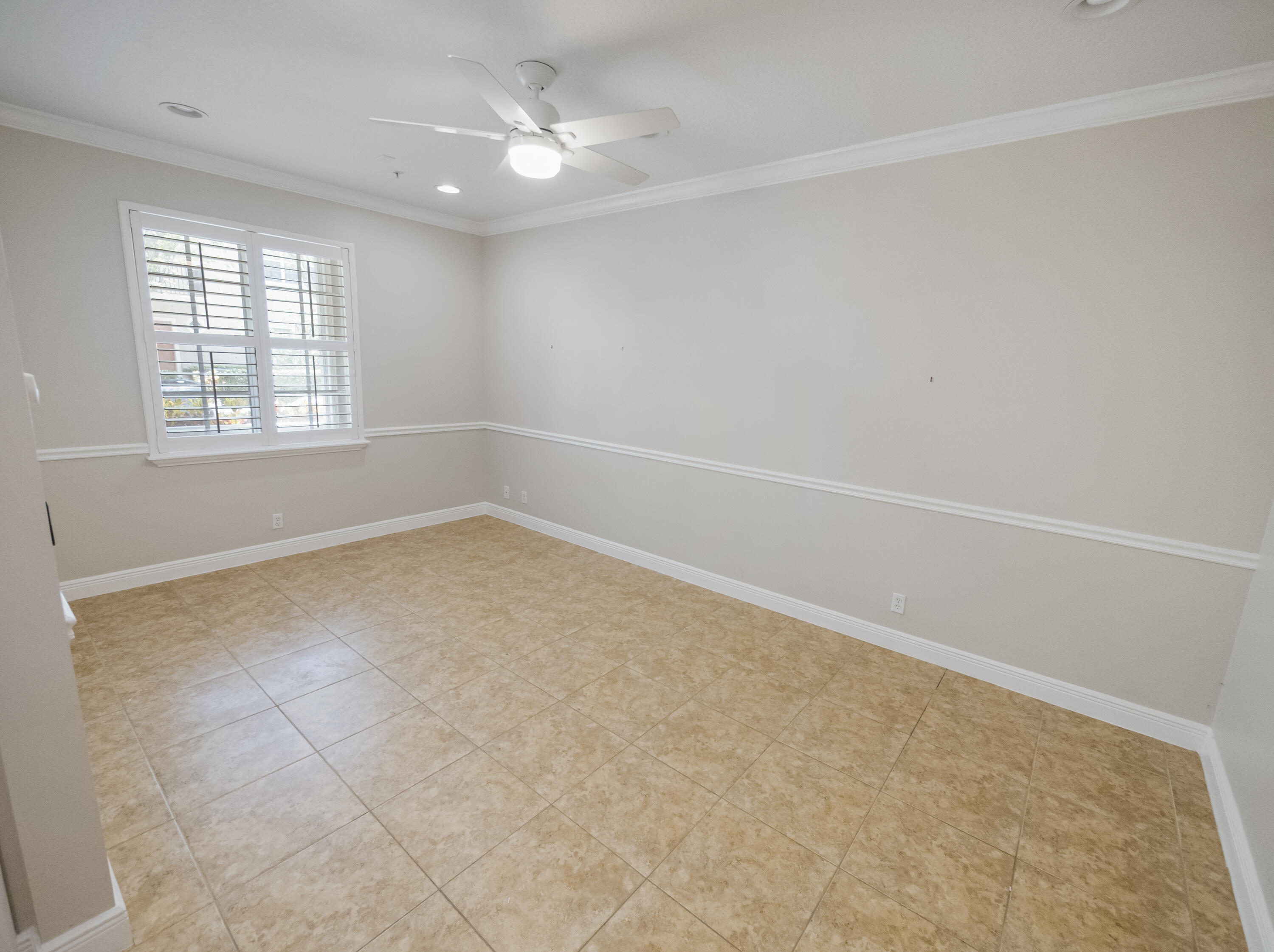 148 Morning Dew Circle Jupiter, FL 33458 - Photo 6 of 21 an empty room with windows and ceiling fan