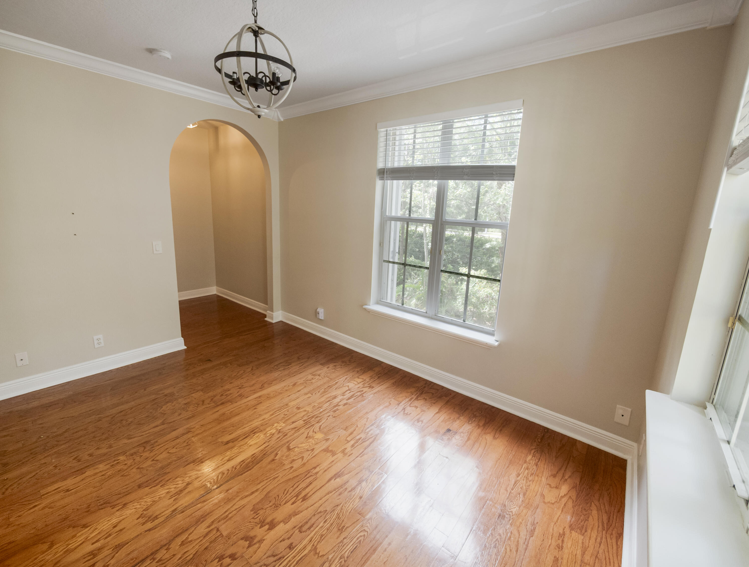 148 Morning Dew Circle Jupiter, FL 33458 - Photo 9 of 21 a view of an empty room with wooden floor and windows