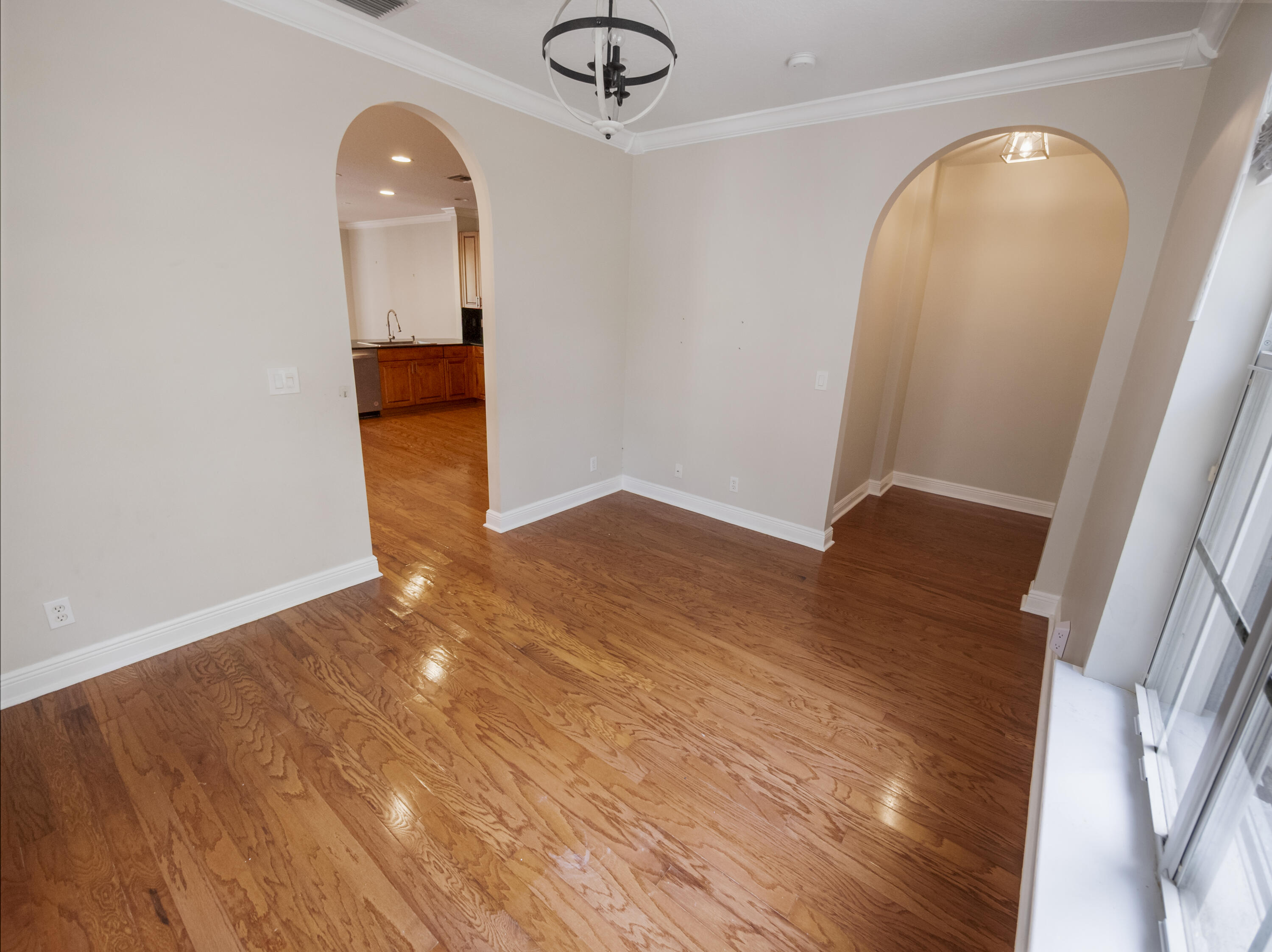 148 Morning Dew Circle Jupiter, FL 33458 - Photo 10 of 21 an empty room with wooden floor and mirror