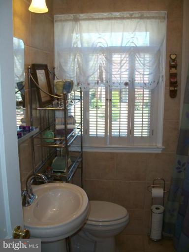 2015 Winford Road Baltimore, MD 21239 - Photo 13 of 22 a bathroom with a sink a toilet and a mirror