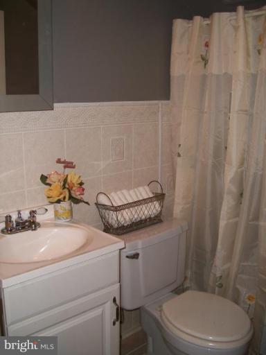 2015 Winford Road Baltimore, MD 21239 - Photo 14 of 22 a bathroom with a sink a toilet and a mirror