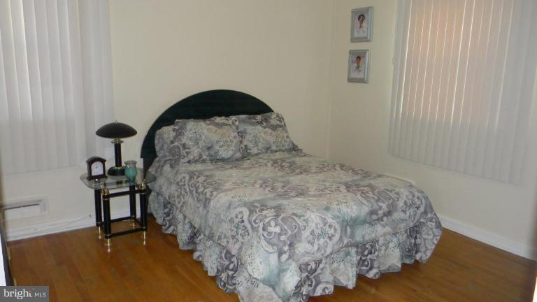 2015 Winford Road Baltimore, MD 21239 - Photo 18 of 22 a bedroom with a bed and a painting on the wall