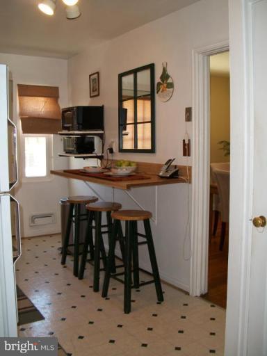 2015 Winford Road Baltimore, MD 21239 - Photo 9 of 22 a kitchen with stainless steel appliances a table and chairs in it
