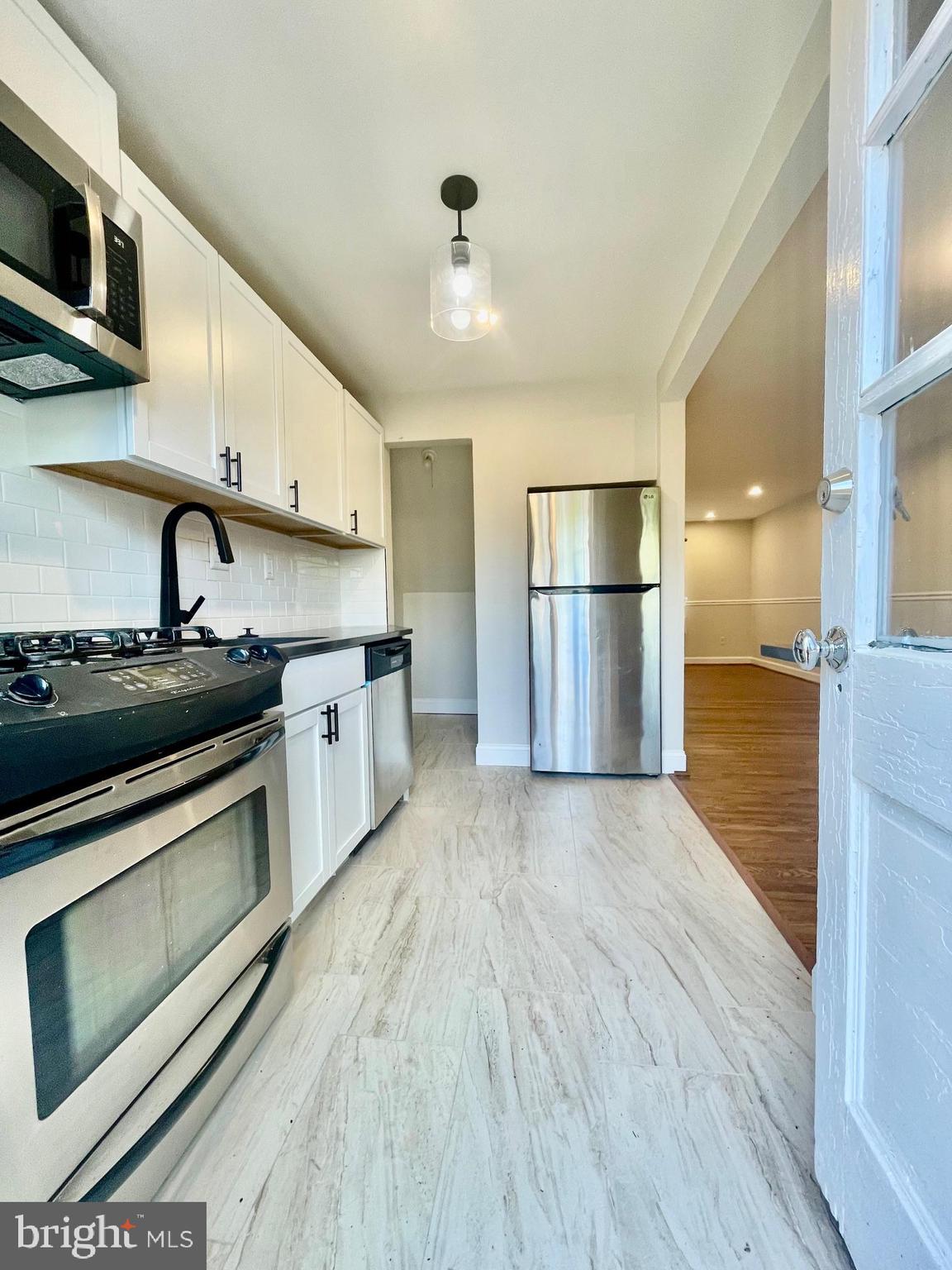 2809 A 16th Road South, Unit 2809A Arlington, VA 22204 - Photo 11 of 13 a kitchen with stainless steel appliances granite countertop a stove a sink and a refrigerator