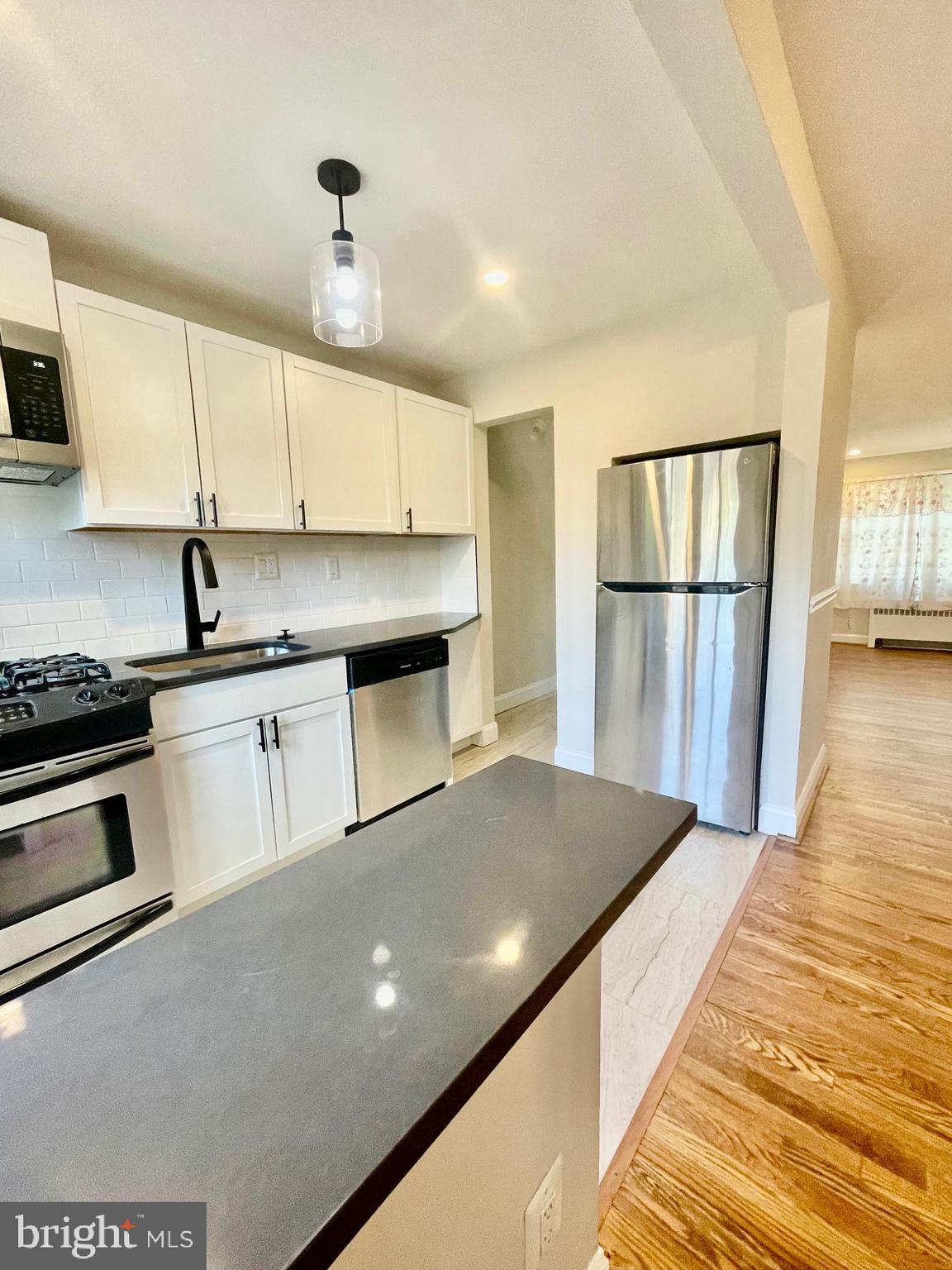 2809 A 16th Road South, Unit 2809A Arlington, VA 22204 - Photo 7 of 13 a kitchen with stainless steel appliances granite countertop a stove a sink dishwasher and a refrigerator