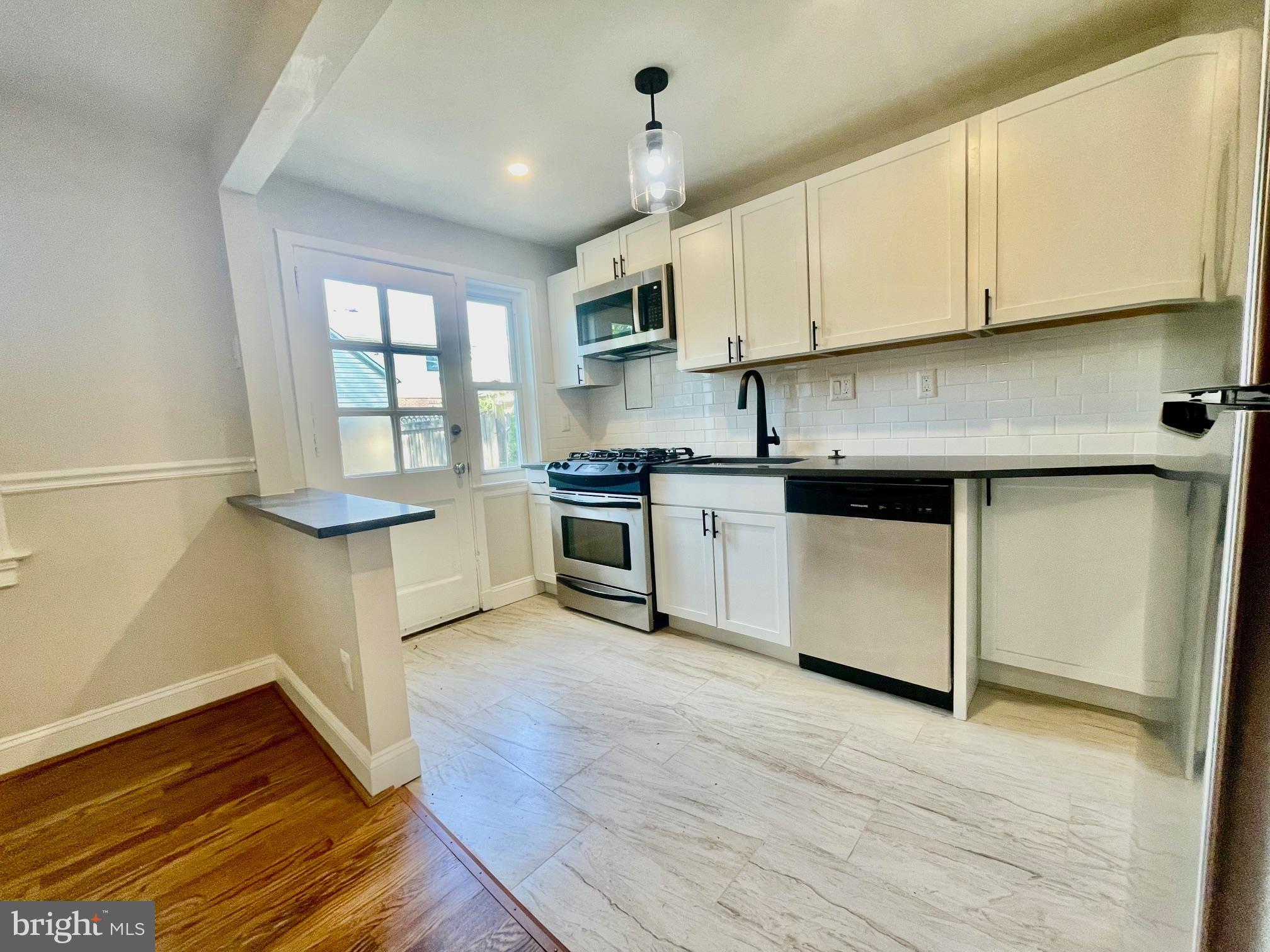 2809 A 16th Road South, Unit 2809A Arlington, VA 22204 - Photo 9 of 13 a kitchen with stainless steel appliances granite countertop a stove a sink and a refrigerator