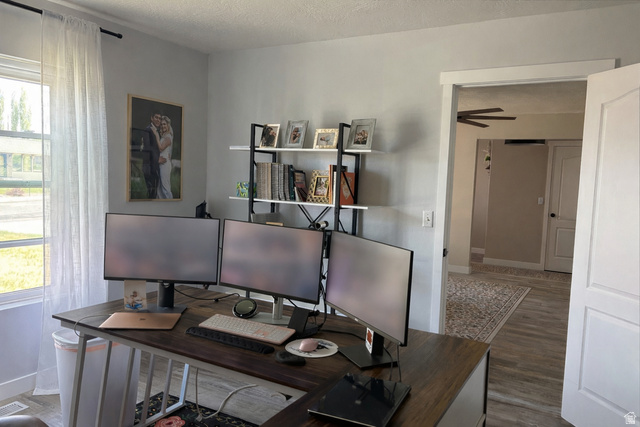 1324 West Raintree Drive, Unit 44 Price, UT 84501 - Photo 8 of 25 Dedicated room with wood-finish flooring, ample natural light from a large window, a built-in wall shelf, and direct access to an interior hallway