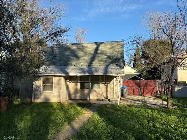 a view of backyard of house with green space