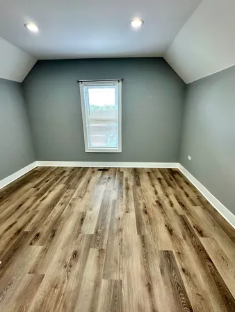 an empty room with wooden floor