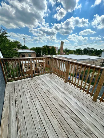 a view of balcony with wooden floor and city view